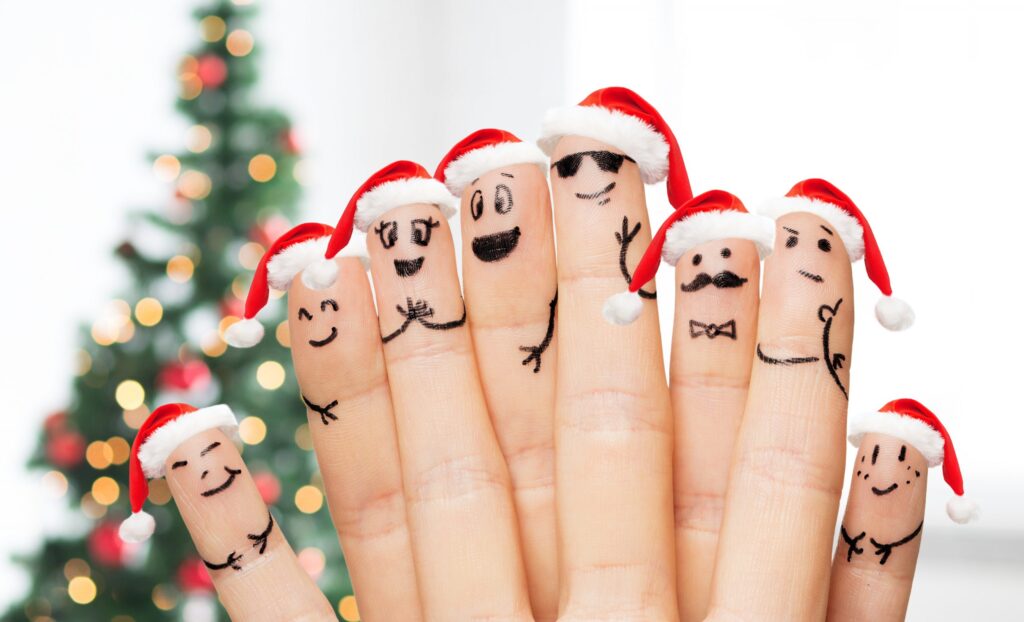 8 fingers with faces and Santa hats on