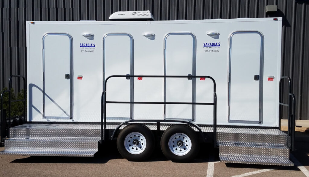 A luxury portable bathroom trailer from Sarabia’s featuring four doors and an AC unit for comfort.
