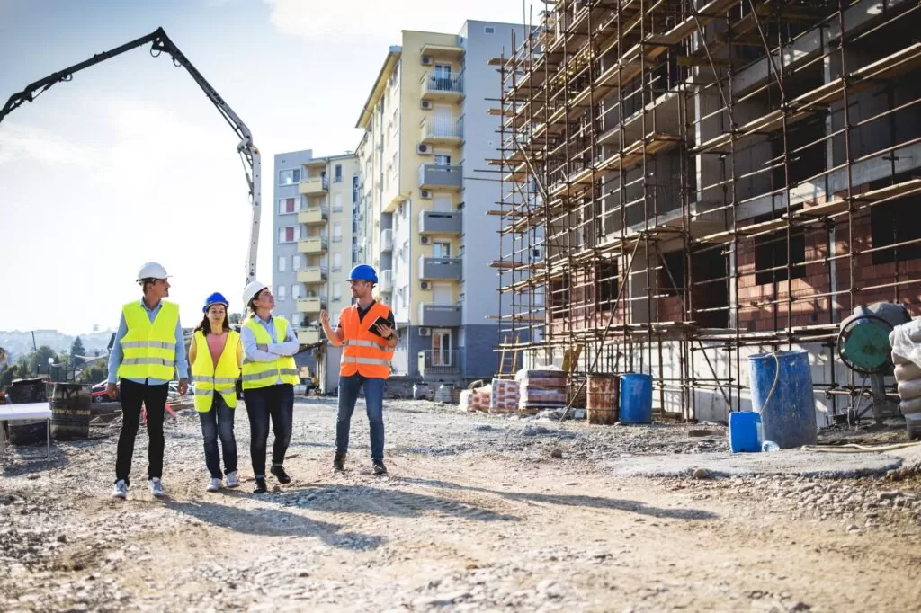 construction site team walking through going over processes and waste management